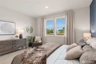 Enjoy natural morning light through the primary bedrooms large windows. Actual home is under construction. Colors, materials, and features may vary. See site agent for details.