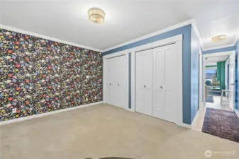 Main bedroom looking down the hall to ensuite on left and living area straight ahead.