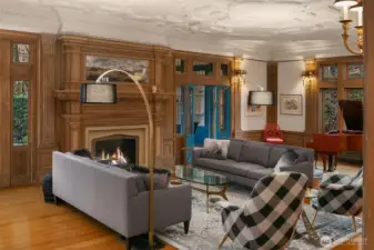 The living room is anchored by a gas fireplace. At approximately 37 feet by 20 feet, there is room for multiple seating areas as well as a grand piano.