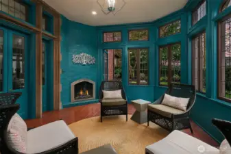 The sitting room, complete with a gas fireplace, is located off the living room.