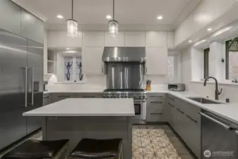 The fully remodelled kitchen features custom cabinetry with under-cabinet lighting, an over-sized island and quartz counters. Stainless Thermador appliances include a 48 inch built-in refrigerator/freezer, an 8 burner range with dual ovens, a commercial vent hood, two dishwashers and a built-in drawer-style microwave.