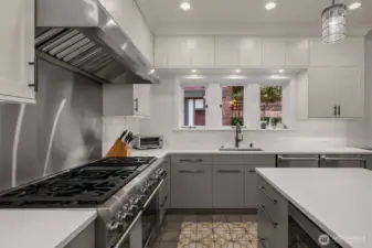 The custom cabinets extend to the ceiling. No wasted space here! A walk-in pantry and mudroom are conveniently located off the kitchen.
