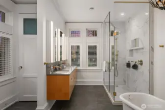 The primary bathroom has double vanities, an oversize walk-in shower, a soaking tub, heated floors and a separate powder room. Access to the roof deck is through a door to the left (not shown).