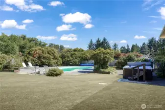 On cooler days and nights, a large hot tub invites you to warm up. When you get too hot, take a dip in your pool! The incredible hedge of rhododendrons gives you a gorgeous natural barrier for privacy.