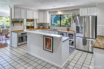 Tile floors and backsplash, butcher block counters, new SS appliances plus a window with a view! What more do you need out of a kitchen?