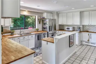 Extensive counter space for cooking and prepping meals in this spacious kitchen. Check out all of those cupboards!