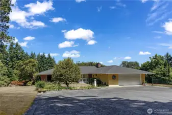 Notice the level access from the parking pad, to paved sidewalk and onward to the front doors. There is an additional entrance to the right of the garage that takes you to the south-facing deck and the doggy run.
