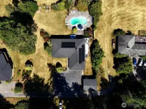 A bird's-eye view of the property. There is a pretty glen on the other side of the rhododendron hedge. Newly installed solar panels keep your power bills to a minimum.