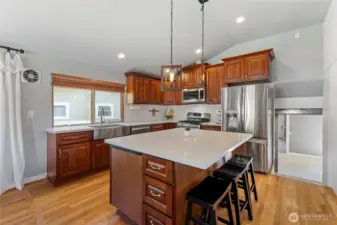 The stairs on the right lead to the lower level -- Utility/Pantry, Family Room, bedroom and full bathroom...or possible multi-generational space?