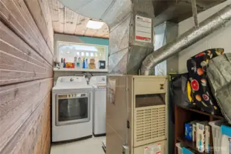 At the beginning of the lower level, there is additional pantry shelving plus laundry space...