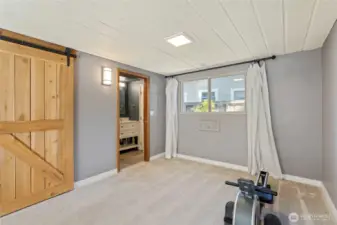 Past the barn doors is the lower level full bathroom...