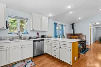 An open kitchen and eating nook made even cozier with a fireplace centerpiece.