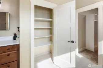 Ample linen closet in primary bathroom