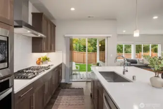 The kitchen flows seamlessly to the covered outdoor patio, ideal for year-round entertaining / grilling.