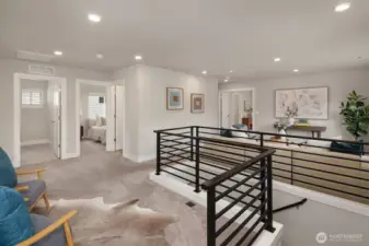 Upper great room with modern railing, plushcarpet and plenty of natural light.
