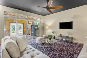 The sliding glass doors leads you to the covered patio with an outdoor kitchen.