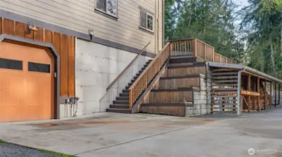 East side garage can fit 2 cars and has an upper level mezzanine for tools or storage.