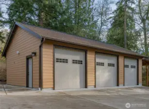 3 car garage and 1 covered carport with outlet. Dedicated 100 electrical panel to this garage.