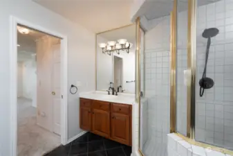 Primary bathroom features double sinks, one on each side of the bathroom. It also features a walk in shower with a bench. There is a jetted tub in the primary bathroom. The primary bathroom also has a newer toilet.