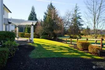 On the north side of the backyard is a playground. The playground area features rubber mulch & a custom painted playhouse to match the home. The rubber mulch area could easily be turned into a raised garden bed area.