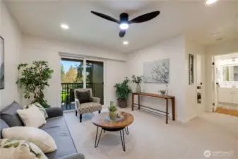 Bright living room with modern ceiling fan and recessed lightings