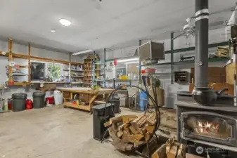 Very cool shop area with lots of shelving, wood heat, hot and cold water.  Check out the rolling table.
