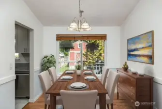 Virtually staged dining room looking out to huge landscaped yard.