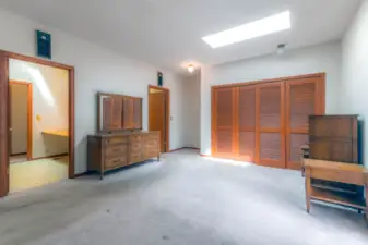 Primary ensuite, showing closet, room used as office to the left, and bathroom door upper left.