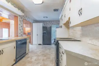 Main Kitchen adjacent to both the dining room and the sitting room/family room.