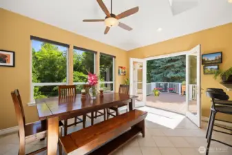 Newer addition of sun drenched dining room with vaulted ceilings and lots of windows and skylight. It feels like you are in a tree house. Patio door open to a spacious deck.