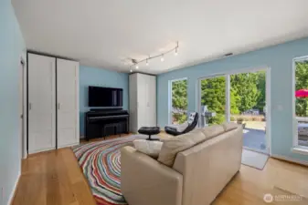 A few steps down from the foyer leads to another living space. Tons of light throughout the day. Sliding patio door to spacious patio