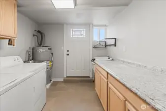 Utility room -mudroom to back yard. Lots of storage.