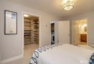 Primary bedroom with walk in closet and built ins.