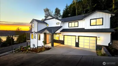 Front of home with large 2 car garage with extra storage space and inviting entryway. Enjoy views of Lake Sammamish right from your driveway!