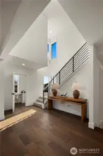 Main Level Landing: Open landing with soaring ceilings and sleek modern railing creates a bright, airy transition between levels. Large windows flood the space with natural light, offering a welcoming pause point that enhances the home’s spacious flow.    Photos are from THIS model home at Foxmoore but are for visualization purposes only.