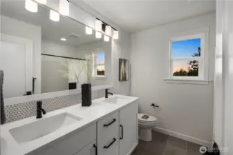 Upper Hall Bath: Full bath features a dual vanity with quartz counters, modern fixtures, and stylish tile details. Perfectly situated to serve the secondary bedrooms with convenience and comfort.    Photos are from THIS model home at Foxmoore but are for visualization purposes only.