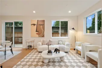 Enter into the airy living room featuring lots of windows and 10' high ceilings.