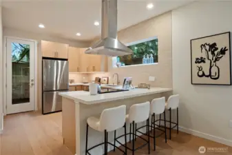 A beautiful full kitchen, complete with a breakfast bar.