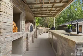 Incredible outdoor kitchen with Pizza Oven, New Smoker, New BBQ, New Granite, New Sink hot and cold, New refrigerator, Trash drop, New SS doors