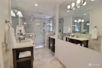Primary Bath with large shower, multiple shower heads, dual vanities, heated floor.