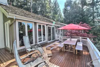 Spacious sunny front deck that wraps around the house to the rear deck.