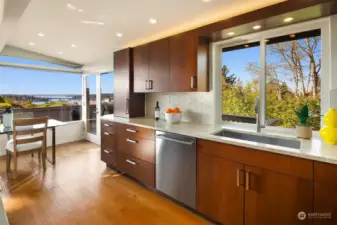 An abundance of pull out drawers, a large stainless sink & recessed/hidden power outlets.