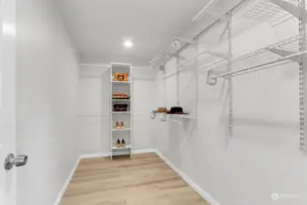 Tons of storage in this walk-in closet with built in shelving system.