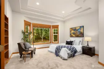 Main floor bedroom with a bay window that offers a serene view.