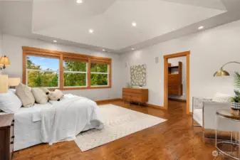 Primary bedroom with a wall of windows to showcase the view.