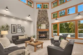 Impressive living room with a soaring ceiling and focal fireplace.