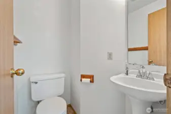 Powder room down stairs in entry way.