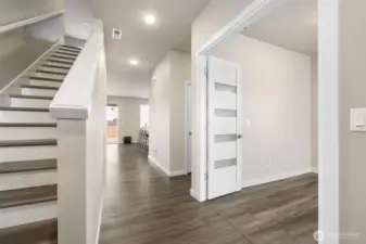 Light-filled entry with instant wow factor — Soaring ceilings, designer flooring, and modern French doors create a grand first impression and lead seamlessly into open-concept living.