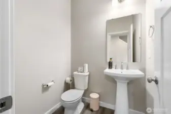 Stylish and convenient main floor powder room — Perfectly placed for guests, with modern fixtures and a clean, timeless design that blends seamlessly with the rest of the home.