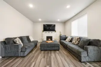 Gather, relax, and make memories — The spacious great room centers around a cozy gas fireplace, offering the perfect blend of warmth, comfort, and modern style for everyday living and entertaining.